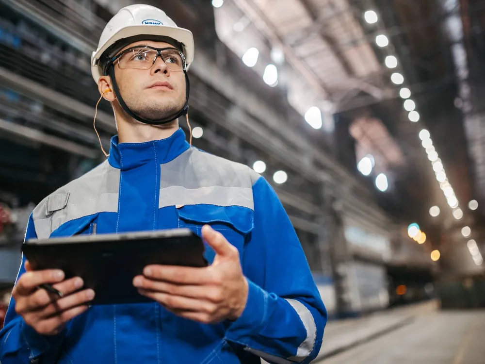 Engineer with tablet during commissioning and inspection in an industrial facility